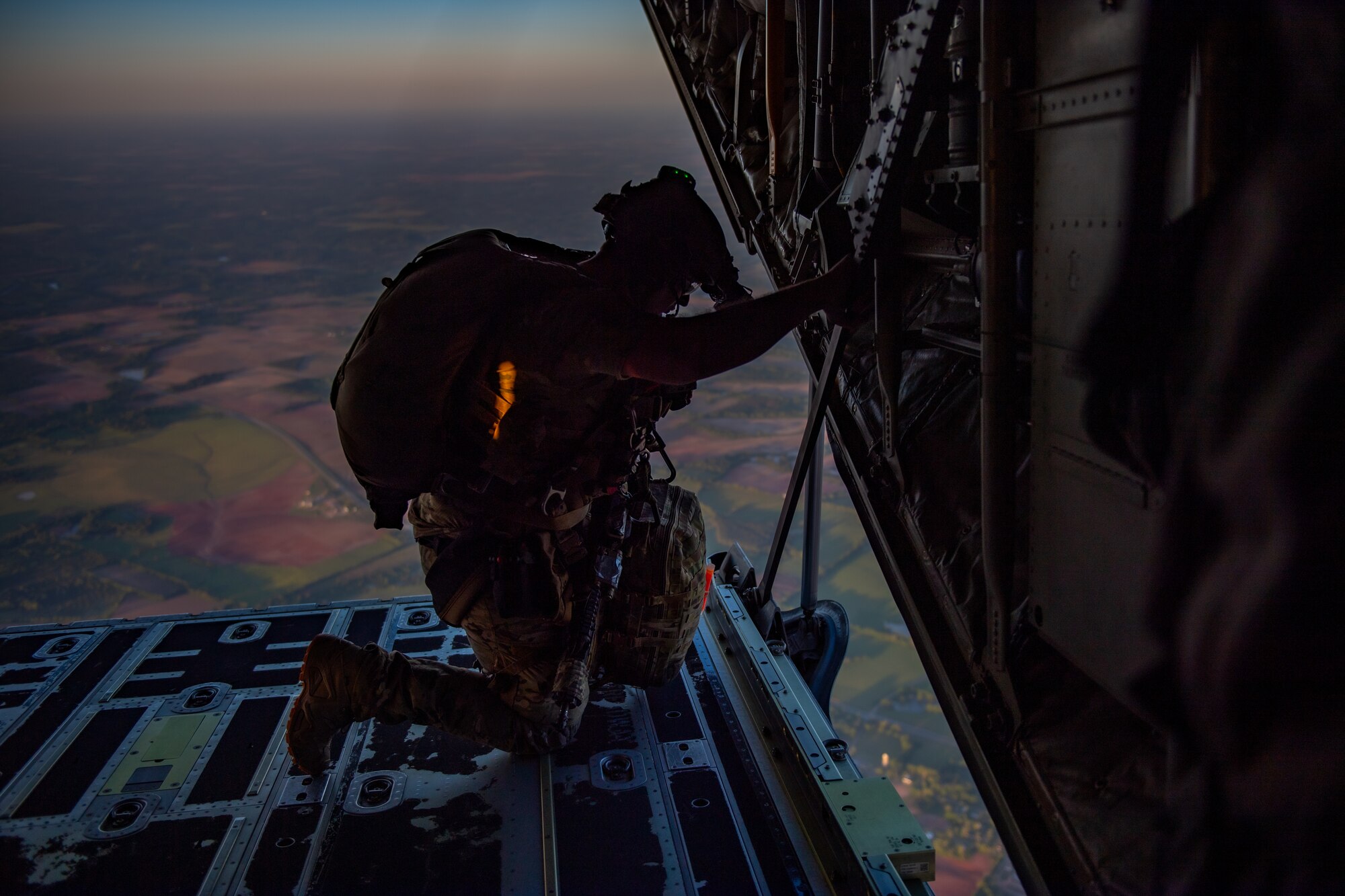 A U.S. Air Force Airman assigned to the 38th Rescue Squadron checks for clearance to do a military free fall jump during Exercise Ready Tiger 24-1, April 12, 2024. The exercise simulated a downed pilot scenario which tested the combat search and rescue team’s ability to respond at a moment's notice from a forward operating site (FOS). During Ready Tiger 24-1, exercise inspectors will assess the 23rd Wing's proficiency in employing decentralized command and control to fulfill air tasking orders across geographically dispersed areas amid communication challenges, integrating Agile Combat Employment principles such as integrated combat turns, forward aerial refueling points, multi-capable Airmen, and combat search and rescue capabilities. (U.S. Air Force photo by Senior Airman Courtney Sebastianelli)