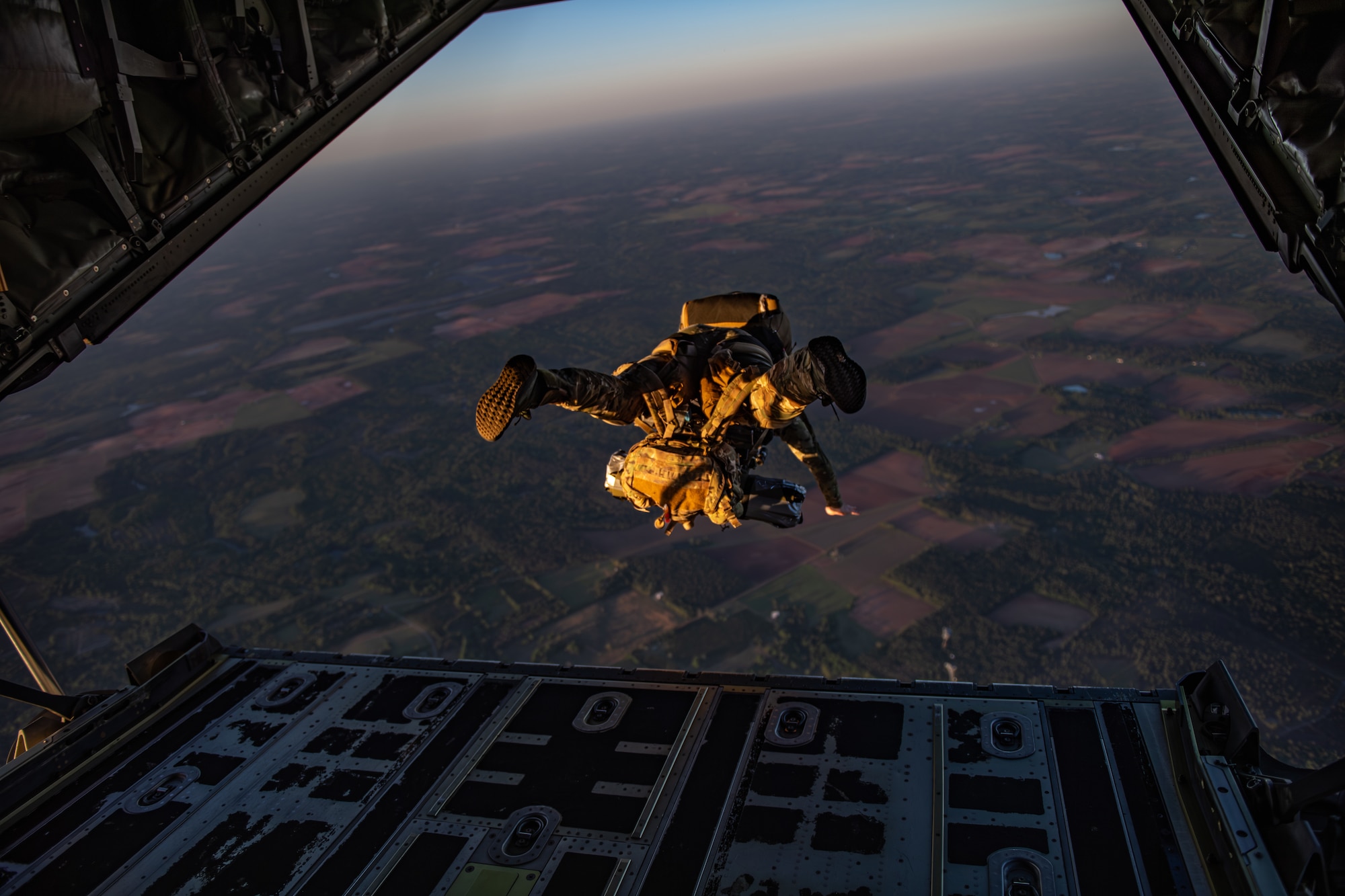 A U.S. Air Force Airman assigned to the 38th Rescue Squadron performs a military free fall jump from an HC-130J Combat King II during Exercise Ready Tiger 24-1, April 12, 2024. The exercise simulated a downed pilot scenario which tested the combat search and rescue team’s ability to respond at a moment's notice. During Ready Tiger 24-1, exercise inspectors will assess the 23rd Wing's proficiency in employing decentralized command and control to fulfill air tasking orders across geographically dispersed areas amid communication challenges, integrating Agile Combat Employment principles such as integrated combat turns, forward aerial refueling points, multi-capable Airmen, and combat search and rescue capabilities. (U.S. Air Force photo by Senior Airman Courtney Sebastianelli)