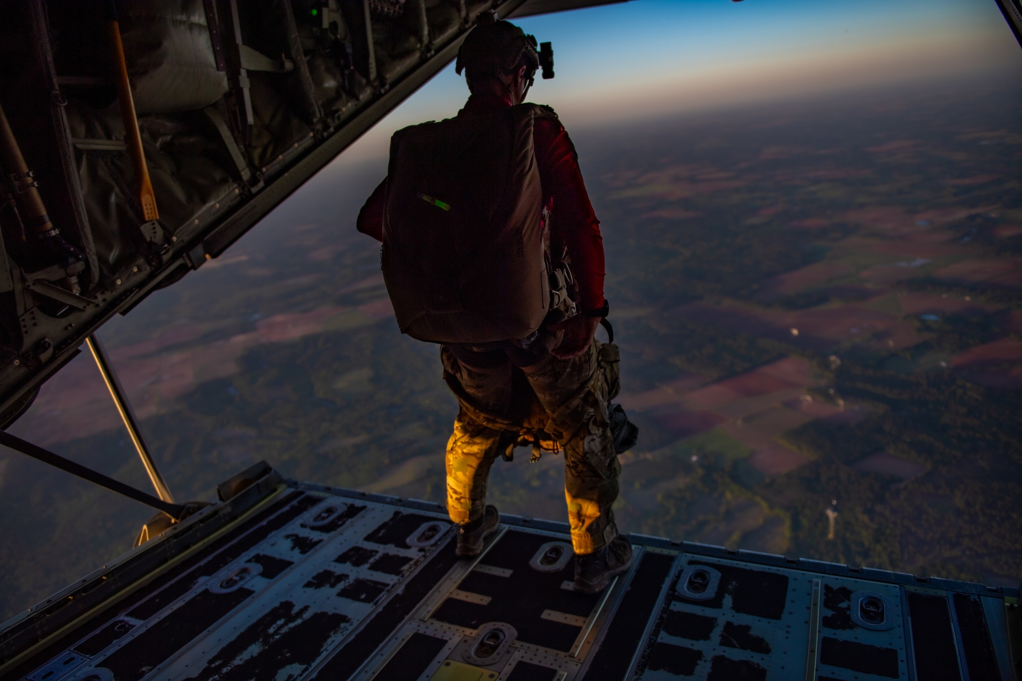 A U.S. Air Force Airman assigned to the 38th Rescue Squadron waits for clearance to do a military free fall jump during Exercise Ready Tiger 24-1, April 12, 2024. The exercise simulated a downed pilot scenario which tested the combat search and rescue team’s ability to respond at a moment's notice. During Ready Tiger 24-1, exercise inspectors will assess the 23rd Wing's proficiency in employing decentralized command and control to fulfill air tasking orders across geographically dispersed areas amid communication challenges, integrating Agile Combat Employment principles such as integrated combat turns, forward aerial refueling points, multi-capable Airmen, and combat search and rescue capabilities. (U.S. Air Force photo by Senior Airman Courtney Sebastianelli)