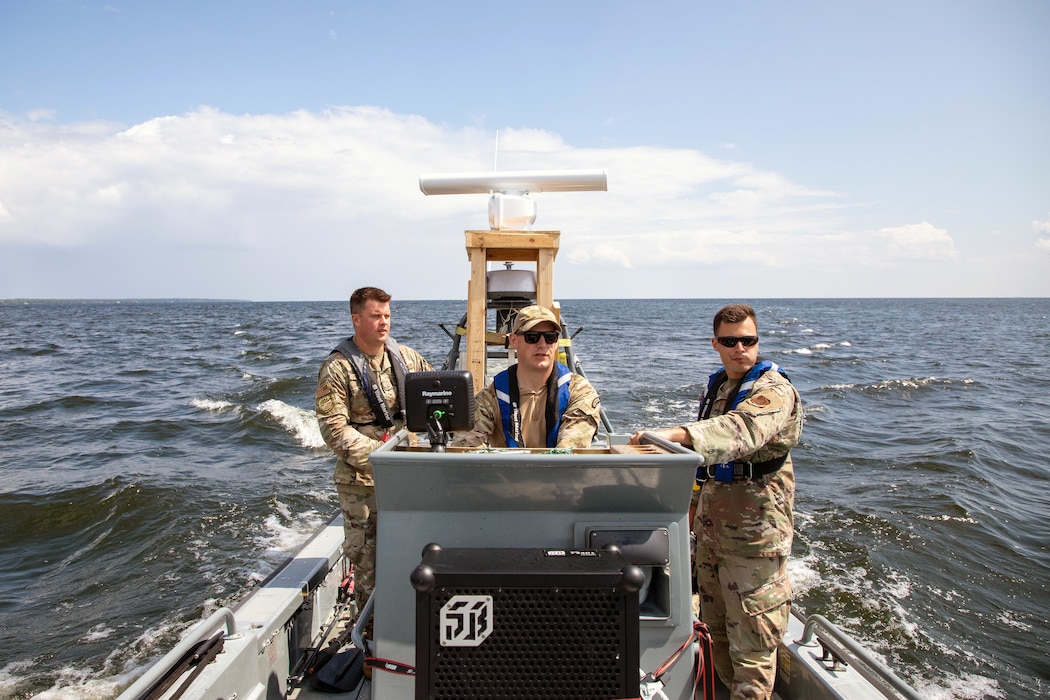 Airmen pilot a boat on Lake Huron