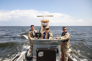 Airmen pilot a boat on Lake Huron