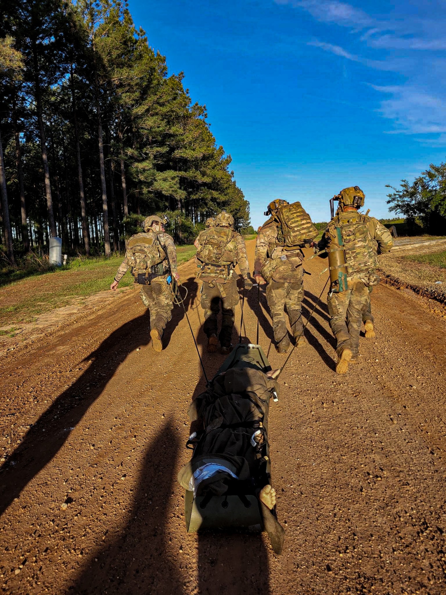 U.S. Air Force pararescuemen assigned to the 38th Rescue Squadron retrieve a simulated killed pilot during Exercise Ready Tiger 24-1 in Georgia, April 13, 2024. The exercise simulated a downed pilot scenario which tested the combat search and rescue team’s ability to respond at a moment's notice. During Ready Tiger 24-1, exercise inspectors will assess the 23rd Wing's proficiency in employing decentralized command and control to fulfill air tasking orders across geographically dispersed areas amid communication challenges, integrating Agile Combat Employment principles such as integrated combat turns, forward aerial refueling points, multi-capable Airmen, and combat search and rescue capabilities. (U.S. Air Force photo by Senior Airman Courtney Sebastianelli)