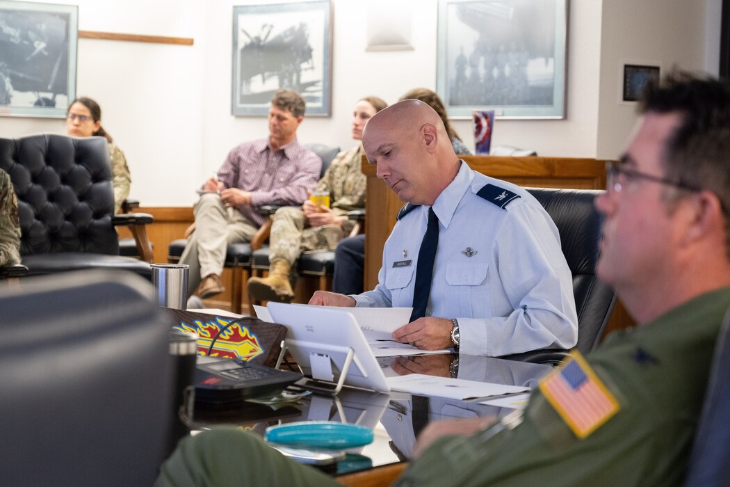 U.S. Air Force Col. Jeff Marshall, 97th Air Mobility Wing commander, looks over notes during pitch day at Altus Air Force Base (AFB), Oklahoma, April 15, 2024. Marshall, along with other 97th AMW leaders, were able to ask the business representatives questions about their potential solutions to problems. (U.S. Air Force Photo by Airman 1st Class Jonah G. Bliss)