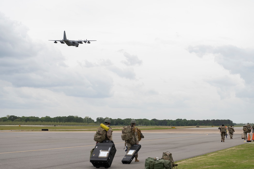 U.S. Air Force Airmen assigned to the 23rd Wing navigate to their new base of operations as an HC-130J Combat King II departs Perry-Houston County Airport, Georgia, April 10, 2024. As part of Exercise Ready Tiger 24-1, the HC-130J provided transport for personnel and equipment between main operating bases, forward operating sites and contingency locations. During Ready Tiger 24-1, the 23rd Wing will be evaluated on the integration of Air Force Force Generation principles such as Agile Combat Employment, integrated combat turns, forward aerial refueling points, multi-capable Airmen, and combat search and rescue capabilities. (U.S. Air Force photo by Senior Airman Rachel Coates)