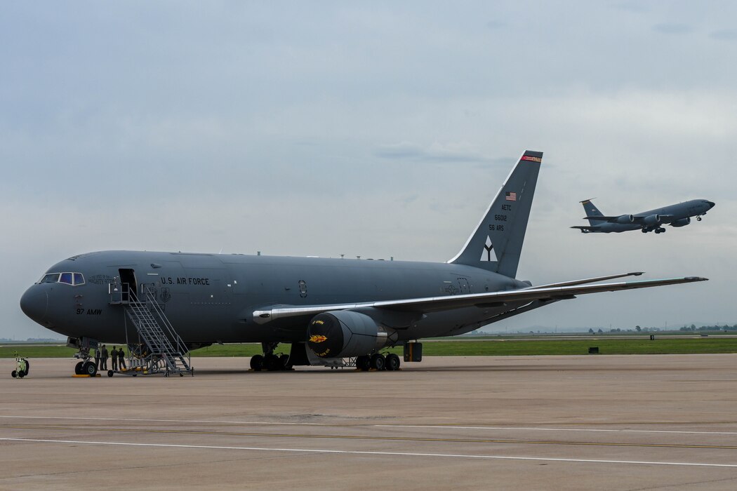 A KC-135 Stratotanker takes off while a KC-46 Pegasus sits on the flightline at Altus Air Force Base (AFB), Oklahoma, April 15, 2024. Twenty-seven aircraft evacuated from Altus AFB due to incoming severe weather. (U.S. Air Force photo by Senior Airman Trenton Jancze)