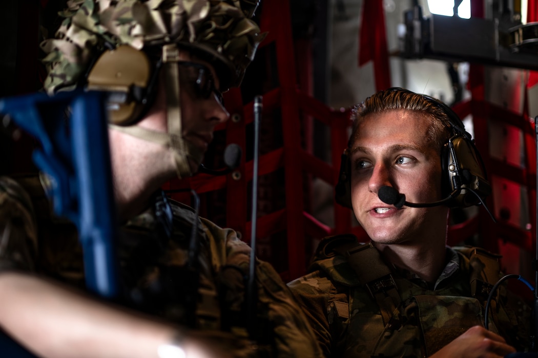 U.S. Air Force Master Sgt. David Peters, 74th Fighter Generation Squadron first sergeant and contingency location commander, speaks with Airman Ethan Isaacs, 23rd Communications Squadron radio frequency apprentice, aboard an HC-130J Combat King II at Avon Park Air Force Range, Florida, April 10, 2024. As part of Exercise Ready Tiger 24-1, Airmen forward deployed to Contingency Location Perry-Houston, Georgia, to provide base security and refueling operations, generating combat airpower at dispersed locations. During Ready Tiger 24-1, the 23rd Wing will be evaluated on the integration of Air Force Force Generation principles such as Agile Combat Employment, integrated combat turns, forward aerial refueling points, multi-capable Airmen, and combat search and rescue capabilities. (U.S. Air Force photo by Tech. Sgt. Devin Boyer)