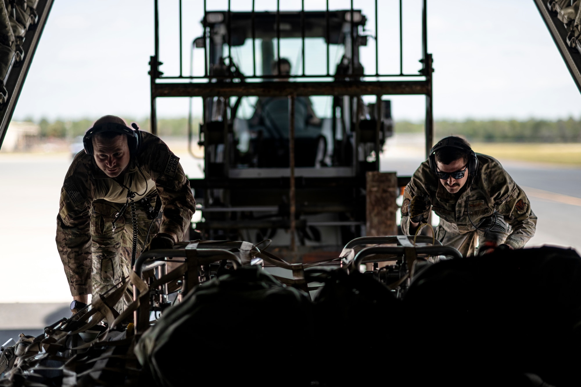 U.S. Air Force loadmasters assigned to the 71st Rescue Squadron push cargo into an HC-130J Combat King II during Exercise Ready Tiger 24-1 at Avon Park Air Force Range, Florida, April 10, 2024. The 71st RQS provided essential airlift support for transporting cargo and personnel, and responded to combat search and rescue scenarios. During Ready Tiger 24-1, the 23rd Wing will be evaluated on the integration of Air Force Force Generation principles such as Agile Combat Employment, integrated combat turns, forward aerial refueling points, multi-capable Airmen, and combat search and rescue capabilities. (U.S. Air Force photo by Tech. Sgt. Devin Boyer)