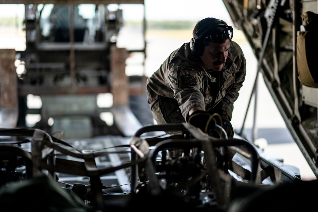 U.S. Air Force Senior Airman James Peterson, 71st Rescue Squadron loadmaster, secures cargo in an HC-130J Combat King II during Exercise Ready Tiger 24-1 at Avon Park Air Force Range, Florida, April 10, 2024. Airmen brought the equipment to Contingency Location Perry-Houston, Georgia, to support refueling operations with a smaller footprint. During Ready Tiger 24-1, the 23rd Wing will be evaluated on the integration of Air Force Force Generation principles such as Agile Combat Employment, integrated combat turns, forward aerial refueling points, multi-capable Airmen, and combat search and rescue capabilities. (U.S. Air Force photo by Tech. Sgt. Devin Boyer)