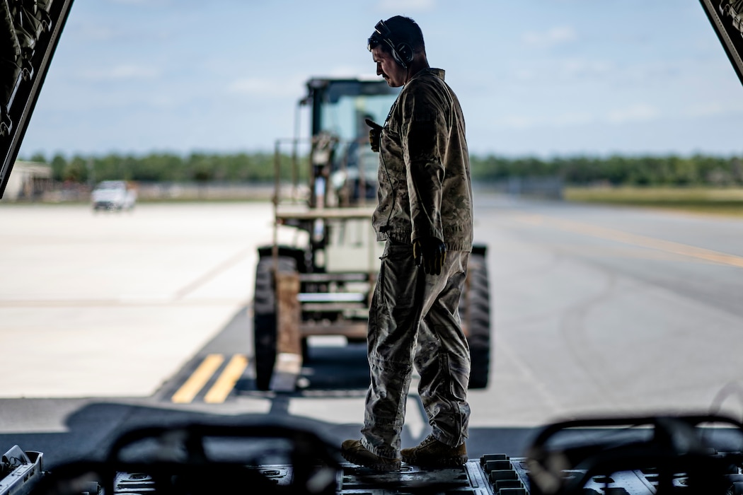 U.S. Air Force Senior Airman James Peterson, 71st Rescue Squadron loadmaster, signals a logistics Airman operating a forklift at Avon Park Air Force Range, Florida, April 10, 2024. As part of Exercise Ready Tiger 24-1, the 71st RQS provided airlift capabilities, transporting critical supplies for Airmen operating at multiple dispersed locations. During Ready Tiger 24-1, the 23rd Wing will be evaluated on the integration of Air Force Force Generation principles such as Agile Combat Employment, integrated combat turns, forward aerial refueling points, multi-capable Airmen, and combat search and rescue capabilities. (U.S. Air Force photo by Tech. Sgt. Devin Boyer)