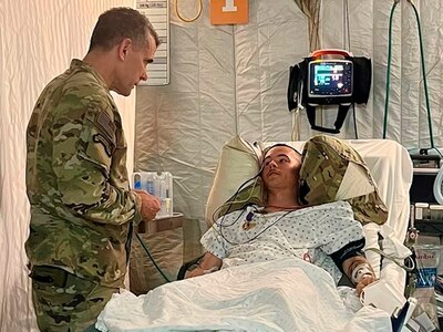 Maj Gen Matthew McFarlane pinned Robison’s Purple Heart and Combat Action badge on him in the ICU in Baghdad.