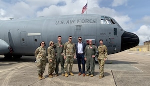 Leadership from the 81st Training Wing, 403rd Wing representatives and MS Secretary of State stand for group photo in front of a C-130J Super Hercules.