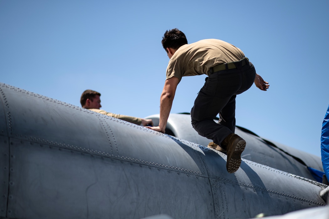 U.S. Air Force Airmen assigned to the 74th Fighter Generation Squadron secure engine covers on an A-10C Thunderbolt II during Exercise Ready Tiger 24-1 at Avon Park Air Force Range, Florida, April 10, 2024. The 74th FGS responded to exercise scenarios, ensuring A-10C Thunderbolt II aircraft could continue their mission in providing combat airpower. During  Ready Tiger 24-1, exercise inspectors will assess the 23rd Wing's proficiency in employing decentralized command and control to fulfill air tasking orders across geographically dispersed areas amid communication challenges, integrating Agile Combat Employment principles such as integrated combat turns, forward aerial refueling points, multi-capable Airmen, and combat search and rescue capabilities. (U.S. Air Force photo by Tech. Sgt. Devin Boyer)