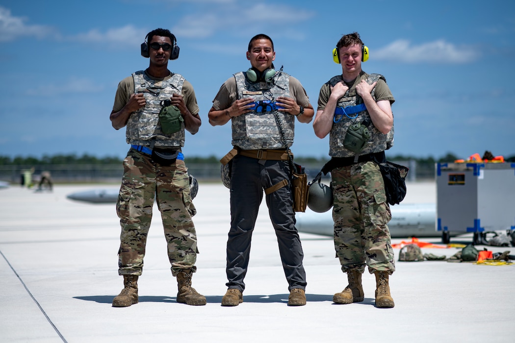 From left to right, U.S. Air Force Senior Airman Christian Jones, Staff Sgt. Eustacio Marquez, and Airman 1st Class Justin Jackson, 74th Fighter Generation Squadron weapons load crew members, pose for a photo at Avon Park Air Force Range, Florida, April 10, 2024. The 74th FGS responded to exercise scenarios, ensuring A-10C Thunderbolt II aircraft could continue their mission in providing combat airpower. During Ready Tiger 24-1, exercise inspectors will assess the 23rd Wing's proficiency in employing decentralized command and control to fulfill air tasking orders across geographically dispersed areas amid communication challenges, integrating Agile Combat Employment principles such as integrated combat turns, forward aerial refueling points, multi-capable Airmen, and combat search and rescue capabilities. (U.S. Air Force photo by Tech. Sgt. Devin Boyer)