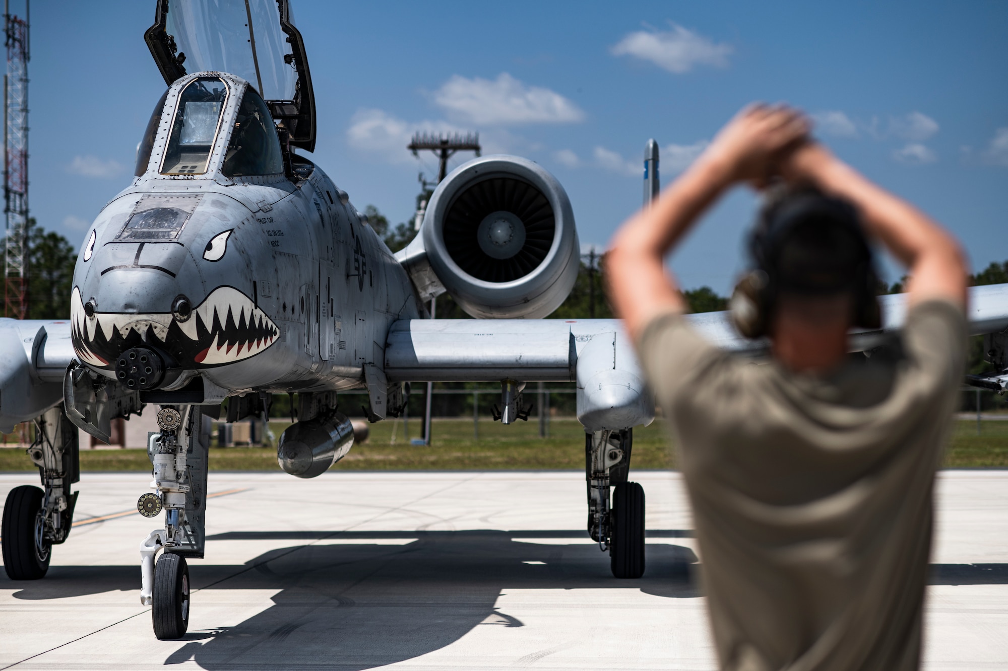 A U.S. Air Force pilot assigned to the 74th Fighter Squadron parks an A-10C Thunderbolt II with the assistance of an Airman assigned to the 74th Fighter Generation Squadron during Exercise Ready Tiger 24-1 at Avon Park Air Force Range, Florida, April 10, 2024. The 74th FS conducted flying operations for the exercise, responding to planned scenarios in a simulated Indo-Pacific area of responsibility. During Ready Tiger 24-1, exercise inspectors will assess the 23rd Wing's proficiency in employing decentralized command and control to fulfill air tasking orders across geographically dispersed areas amid communication challenges, integrating Agile Combat Employment principles such as integrated combat turns, forward aerial refueling points, multi-capable Airmen, and combat search and rescue capabilities. (U.S. Air Force photo by Tech. Sgt. Devin Boyer)