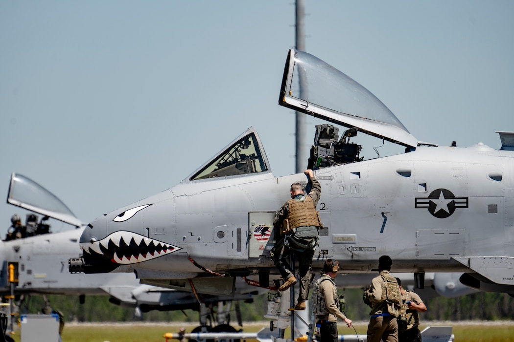 A U.S. Air Force Airman assigned to the 74th Fighter Generation Squadron climbs up an A-10C Thunderbolt II at Avon Park Air Force Range, Florida, during Exercise Ready Tiger 24-1, April 12, 2024. The 74th FGS ensured aircraft were able to continue operations in a simulated Indo-Pacific region while applying Agile Combat Employment concepts. The Ready Tiger 24-1 exercise evaluators will assess the 23rd Wing's proficiency in employing decentralized command and control to fulfill air tasking orders across geographically dispersed areas amid communication challenges. (U.S. Air Force photo by Tech. Sgt. Devin Boyer)