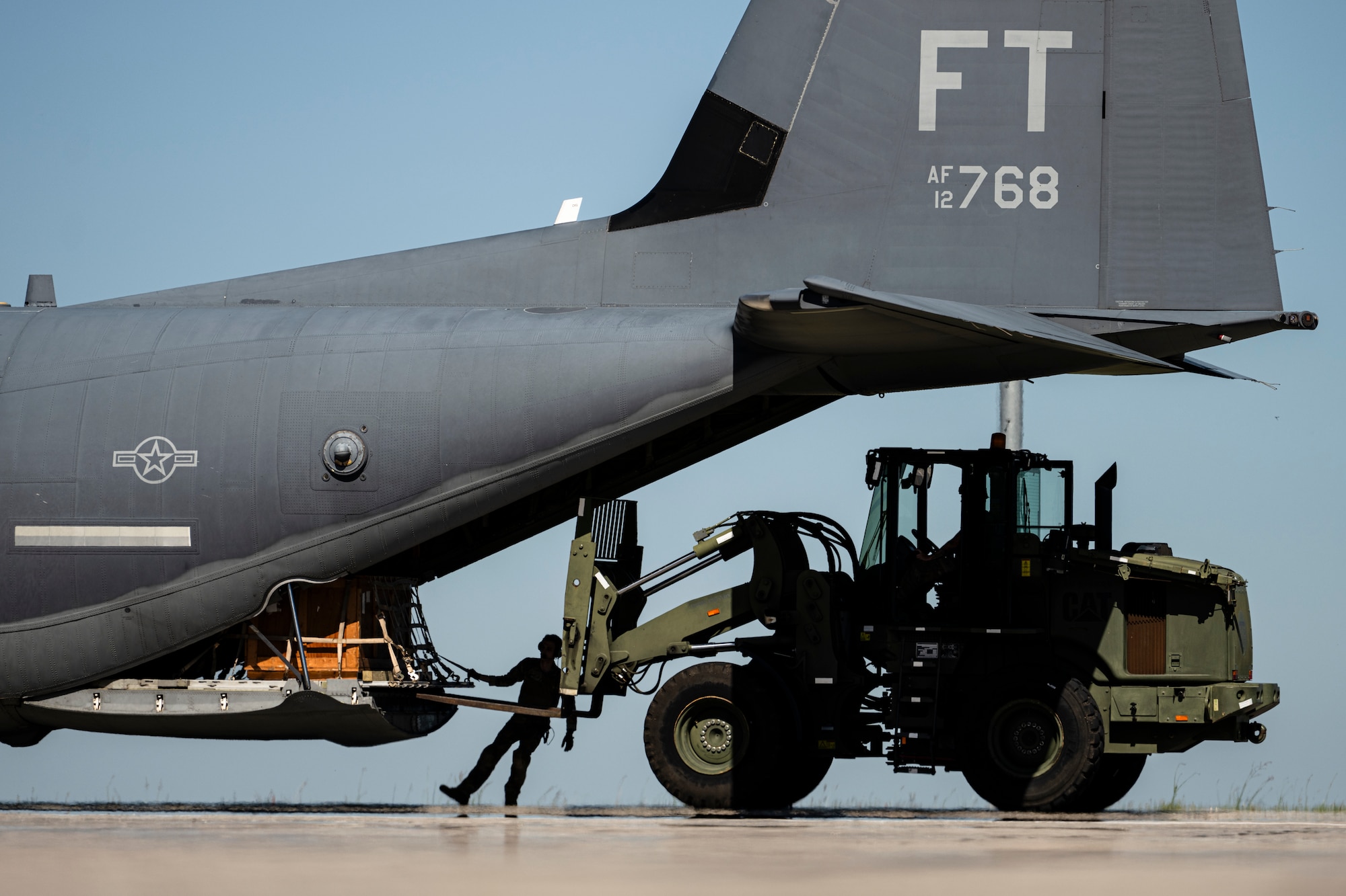 U.S. Air Force Airmen assigned to the 23rd Logistics Readiness Squadron and 71st Rescue Squadron download cargo from an HC-130J Combat King II during Exercise Ready Tiger 24-1 at Avon Park Air Force Range, Florida, April 12, 2024. The 23rd LRS played a crucial role in resupplying the forward operating sites and contingency locations for the exercise. The Ready Tiger 24-1 exercise evaluators will assess the 23rd Wing's proficiency in employing decentralized command and control to fulfill air tasking orders across geographically dispersed areas amid communication challenges. (U.S. Air Force photo by Tech. Sgt. Devin Boyer)