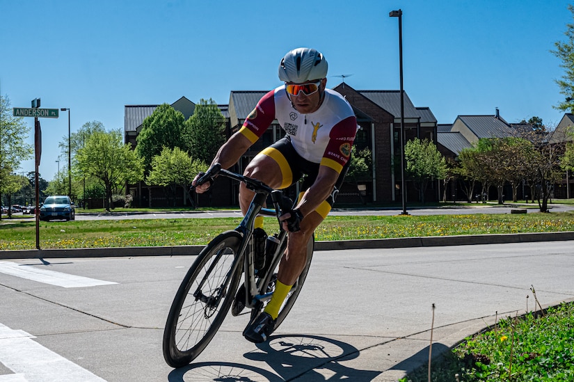 Military and civilians bike during a race on the road