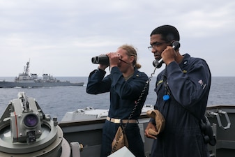 Sailors aboard USS Howard (DDG 83) stand watch on the bridge wing in the East China Sea.
