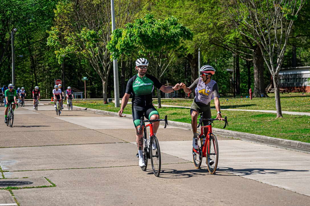 Military and civilians bike during a race on the road