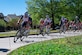 Cyclists race down Anderson street during the second annual Fort Eustis Circuit Race at Joint Base Langley-Eustis, Virginia, April 14, 2024. The race is part of “Tour of Newport News,” a three-day event the City of Newport News’ Parks & Rec., Department hosts in an effort to further grow Mid-Atlantic racing. (U.S. Air Force photo by Senior Airman Olivia Bithell)