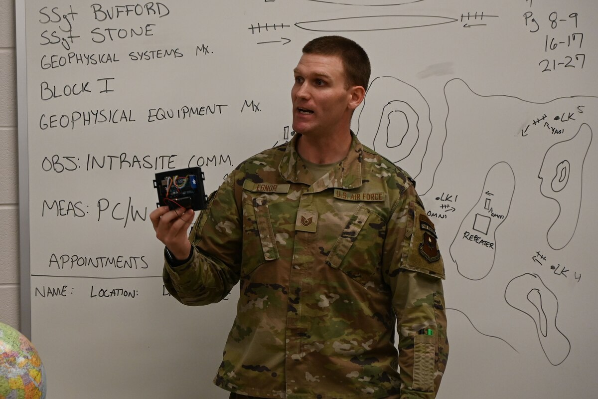 U.S. Air Force Tech. Sgt. Clinton Egnor, 312th Training Squadron instructor, demonstrates how students’ creation is used at the Louis F. Garland Department of Defense Fire Academy at Goodfellow Air Force Base, Texas, April 11, 2024. The students attached the device to light poles around the fire academy to track which poles needed maintenance. (U.S. Air Force photo by Airman 1st Class Brian Lummus)