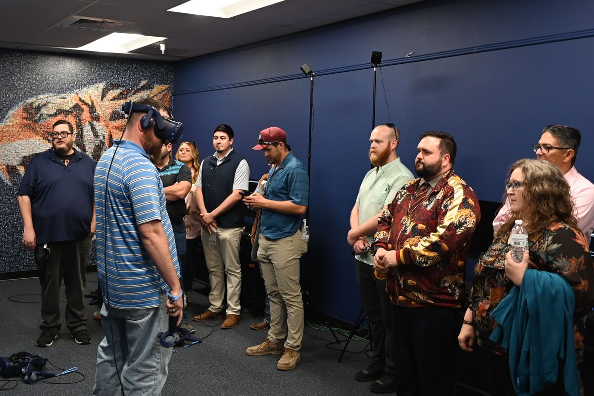 Evan Reeves, 17th Training Support Squadron interactive multimedia instruction developer, demonstrates the Build-A-Bomb program using a VR headset at the 17th TRSS at Goodfellow Air Force Base, Texas, April 11, 2024. The program taught service members how to construct bombs without requiring expensive and dangerous components shipped to their location. (U.S. Air Force photo by Airman 1st Class Brian Lummus)