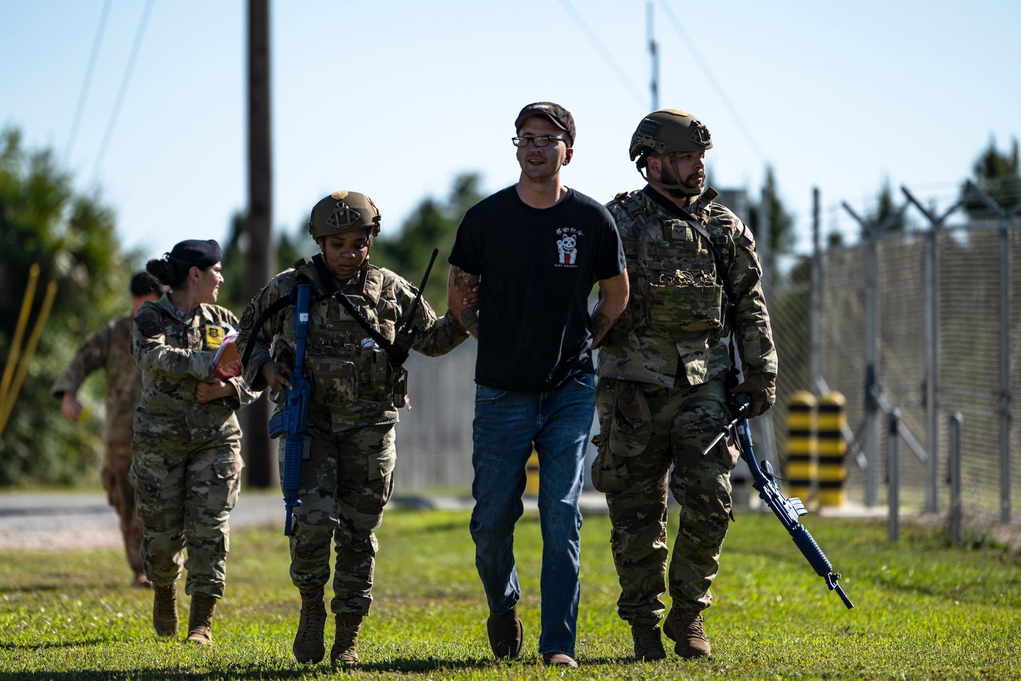 U.S. Air Force Airmen assigned to the 23rd Security Forces Squadron apprehend an aggressive protester for a training scenario at Avon Air Force Range, Florida, April 12, 2024. The training scenario was part of Exercise Ready Tiger 24-1 designed to test base defense capabilities and de-escalation techniques. The Ready Tiger 24-1 exercise evaluators will assess the 23rd Wing's proficiency in employing decentralized command and control to fulfill air tasking orders across geographically dispersed areas amid communication challenges. (U.S. Air Force photo by Tech. Sgt. Devin Boyer)