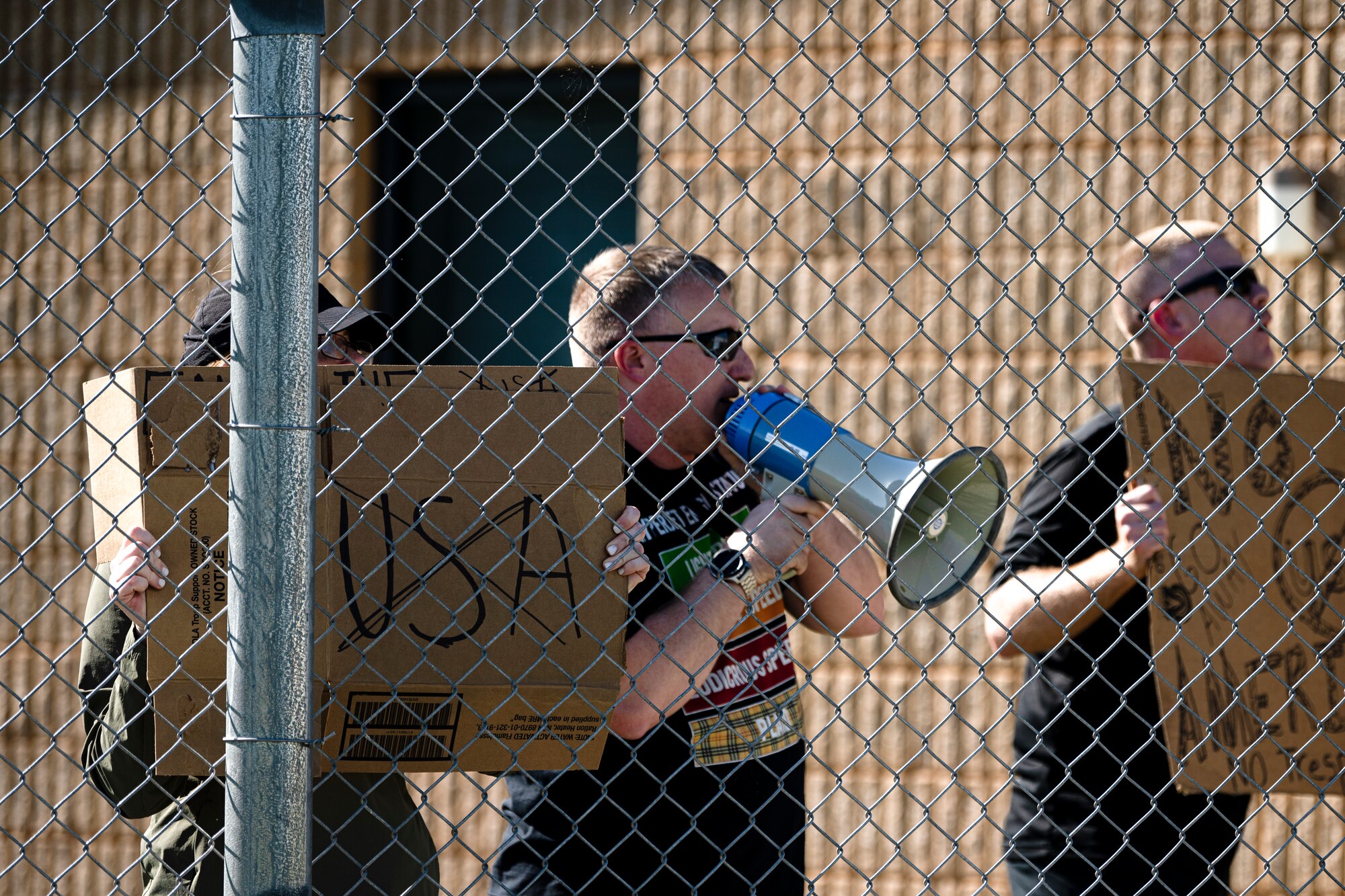 Exercise Ready Tiger 24-1 actors protest outside Forward Operating Site Avon for a training scenario at Avon Park Air Force Range, Florida, April 12, 2024. The training scenario tested base defense capabilities and de-escalation techniques. The Ready Tiger 24-1 exercise evaluators will assess the 23rd Wing's proficiency in employing decentralized command and control to fulfill air tasking orders across geographically dispersed areas amid communication challenges. (U.S. Air Force photo by Tech. Sgt. Devin Boyer)