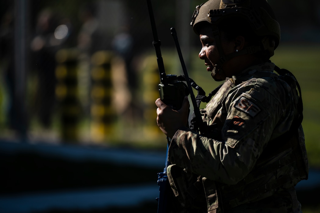 U.S. Air Force Tech. Sgt. Sashia Euley, 23rd Security Forces Squadron Alpha Flight sergeant, speaks over a radio during Exercise Ready Tiger 24-1 at Avon Park Air Force Range, Florida, April 12, 2024. Security forces Airmen and augmentees worked together to de-escalate the protest and ensure security for personnel and assets at Forward Operating Site Avon. The Ready Tiger 24-1 exercise evaluators will assess the 23rd Wing's proficiency in employing decentralized command and control to fulfill air tasking orders across geographically dispersed areas amid communication challenges. (U.S. Air Force photo by Tech. Sgt. Devin Boyer)