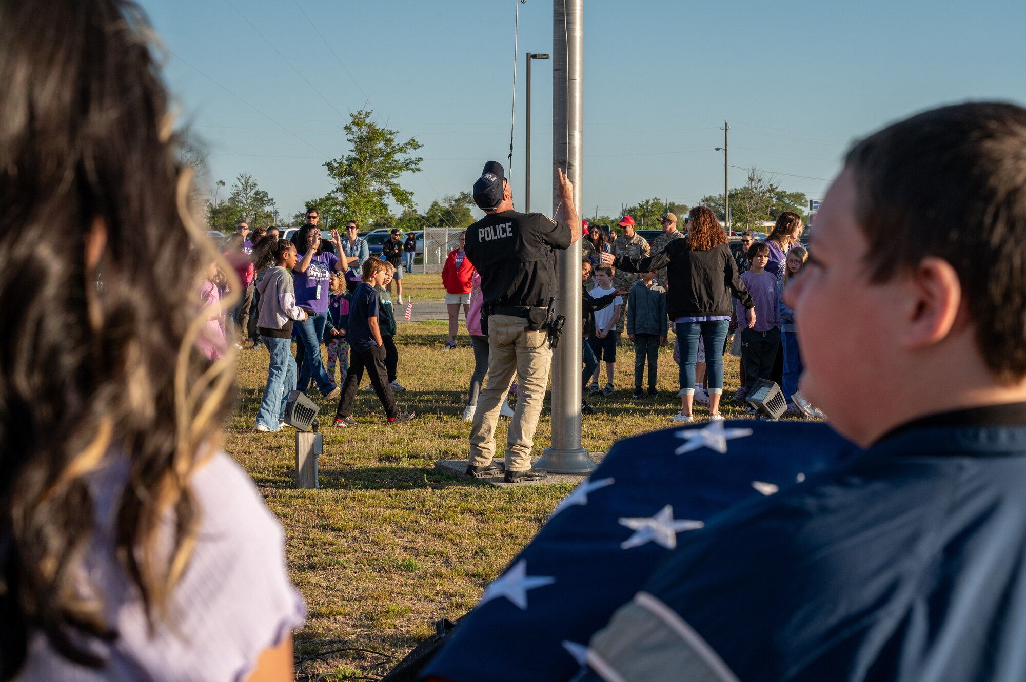 A person prepares to raise the American Flag