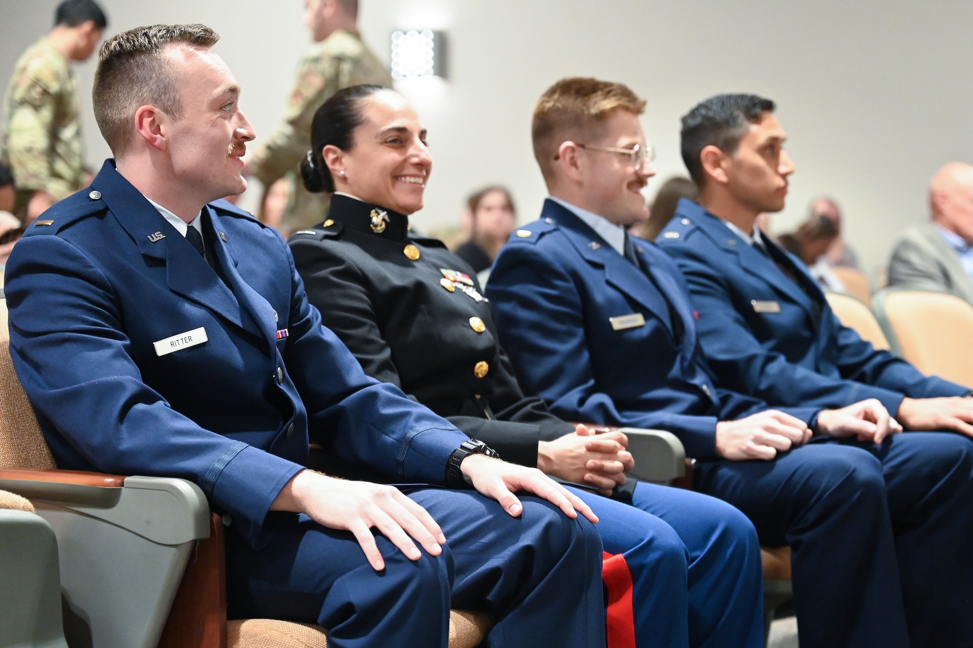 A photo of Airmen and Marines talking.