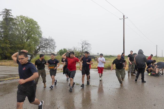 U.S. Marine Corps poolees with Recruiting Sub-Stations Manteca, Merced, Modesto and Stockton, Recruiting Station Sacramento, carry ammunition cans and a weighted gurney during a squad competition at Defense Depot San Joaquin Sharpe in Lathrop, Calif., April 13. The event was held to build esprit de corps and morale amongst the poolees. (U.S. Marine Corps photo by Sgt. Ryan Harvey)