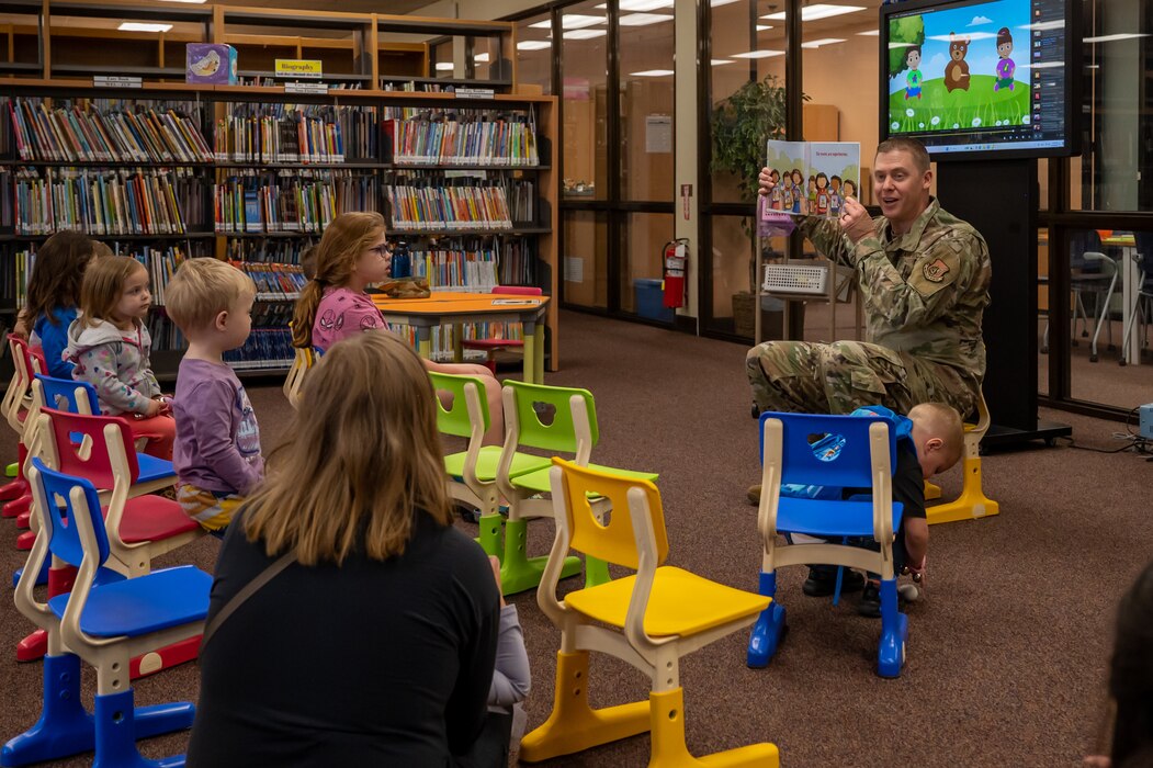 U.S. Air Force Col. Kyle Grygo, 51st Mission Support Group commander, reads to children at Osan Air Base, Republic of Korea, April 16, 2024. The reading session took place to celebrate Month of the Military Child, which recognizes the sacrifices made by children of military members. (U.S. Air Force photo by Senior Airman Brittany Russell)