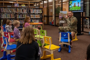 U.S. Air Force Col. Kyle Grygo, 51st Mission Support Group commander, reads to children at Osan Air Base, Republic of Korea, April 16, 2024. The reading session took place to celebrate Month of the Military Child, which recognizes the sacrifices made by children of military members. (U.S. Air Force photo by Senior Airman Brittany Russell)