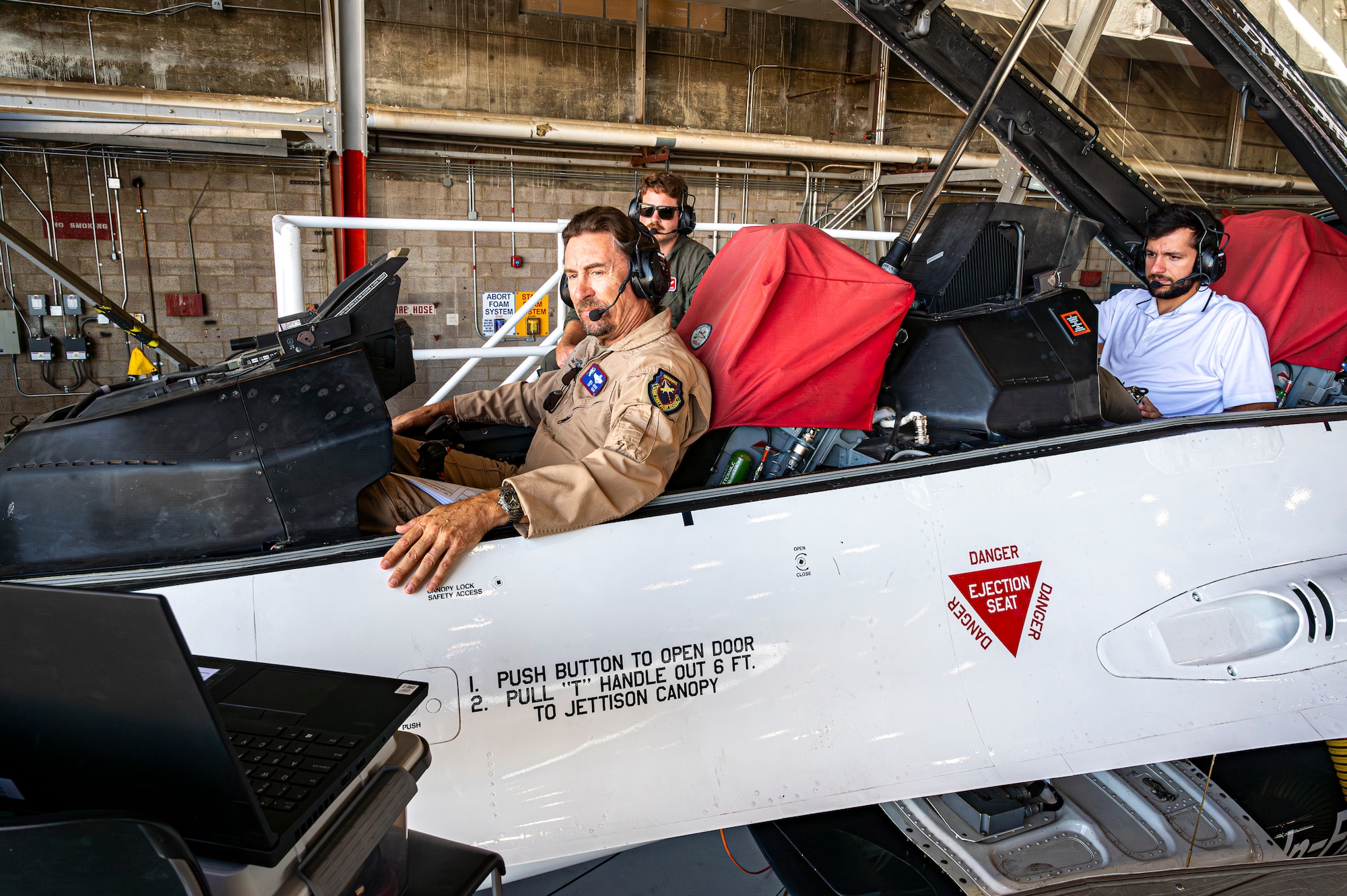 William Gray, Chief Test Pilot, Air Force Test Pilot School, and other engineers conduct software updates to the X-62 Variable Stability In-Flight Simulator Test Aircraft at Edwards Air Force Base, California, Aug. 3, 2022. (Air Force photo by Giancarlo Casem)