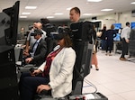 Council members try the pilot training simulators.