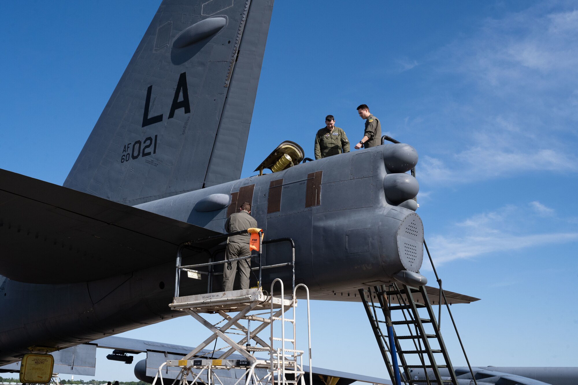 Senior Airman Justin Whitehead, 2nd Aircraft Maintenance Squadron crew chief, Capt. Joshua Benard, 20th Bomb Squadron radar navigator, and Capt. Stephen O’Donnell, 20th Bomb Squadron electron warfare navigator, prepare to load a drag chute into a B-52H Stratofortress after landing at Chennault International Airport, La., during exercise Bayou Vigilance April 12, 2024. This exercise was conducted with a focus on the safe and secure handling of assets and capabilities that comprise the nuclear triad. (U.S. Air Force photo by Senior Airman Nicole Ledbetter)