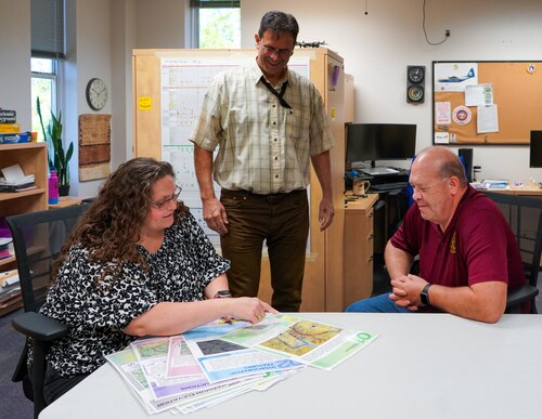 Joyce Tupola, John Bir, and Charles Rich, Curriculum Development team members at the Defense Language Institute English Language Center, evaluate supplemental training materials at Joint Base San Antonio-Lackland, Texas, March 8, 2024. The Defense Language Institute English Language Center at Joint Base San Antonio-Lackland is known as the “Gateway to America.” DLIELC builds security cooperation through English language training and cultural immersion for international military partners and pre-basic combat trainees in the U.S. Army and Coast Guard.  (U.S. Air Force photo by Agnes Koterba)