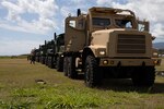 U.S. Marines with Marine Aviation Logistics Squadron (MALS) 24, Marine Aircraft Group 24,1st Marine Aircraft Wing, stage transport vehicles at Marine Corps Base Hawaii, Apr. 15, 2024. The purpose of MALS-24's Displaced Warrior exercise is to demonstrate their ability to set up power mobile maintenance facilities, assist flight operations and deliver supply support in an austere environment. (U.S. Marine Corps photo by Lance Cpl. Jose Villasenor)