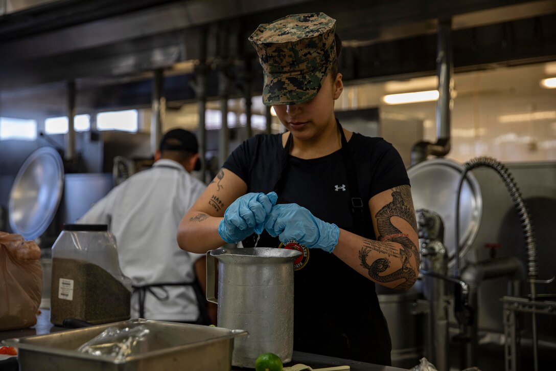U.S. Marine Corps Private First Class. Emeli Beltran, a food service specialist, with Combat Logistics Squadron 37, 3rd Division Marine Logistics Group Food Service Company, and a native of California, prepares a dish during the Chef of the Quarter competition at Marine Corps Air Station Iwakuni, Japan, April 12, 2024. Chef of the Quarter is an event where Marines from across Marine Corps Installations Pacific compete in a cooking contest, where their food was judged by MCAS Iwakuni leadership. (U.S. Marine Corps photo by Lance Cpl. David Getz)
