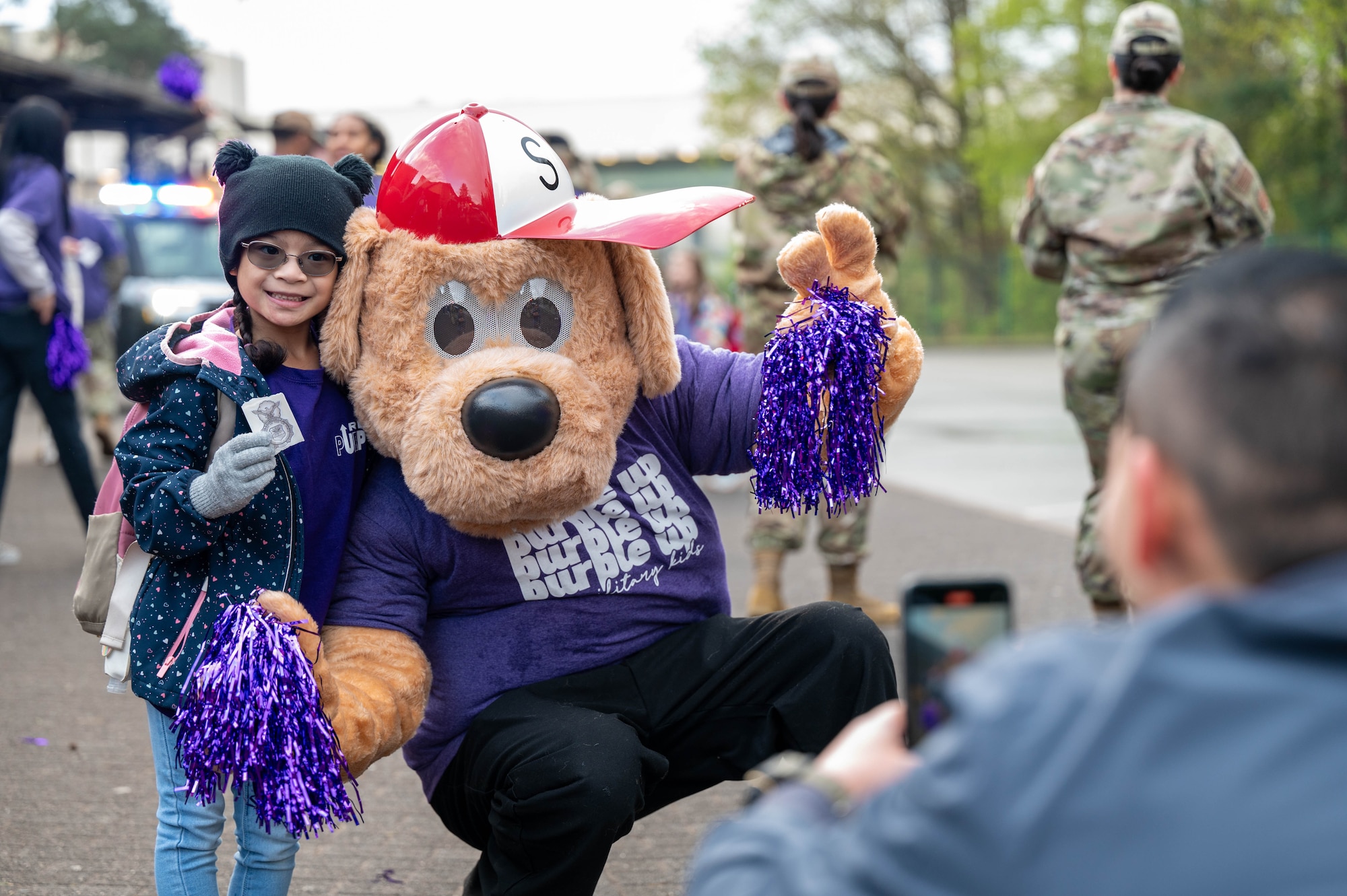 A father takes a picture of their child during the Purple Up! Day at Ramstein Air Base, Germany, April 17, 2024.