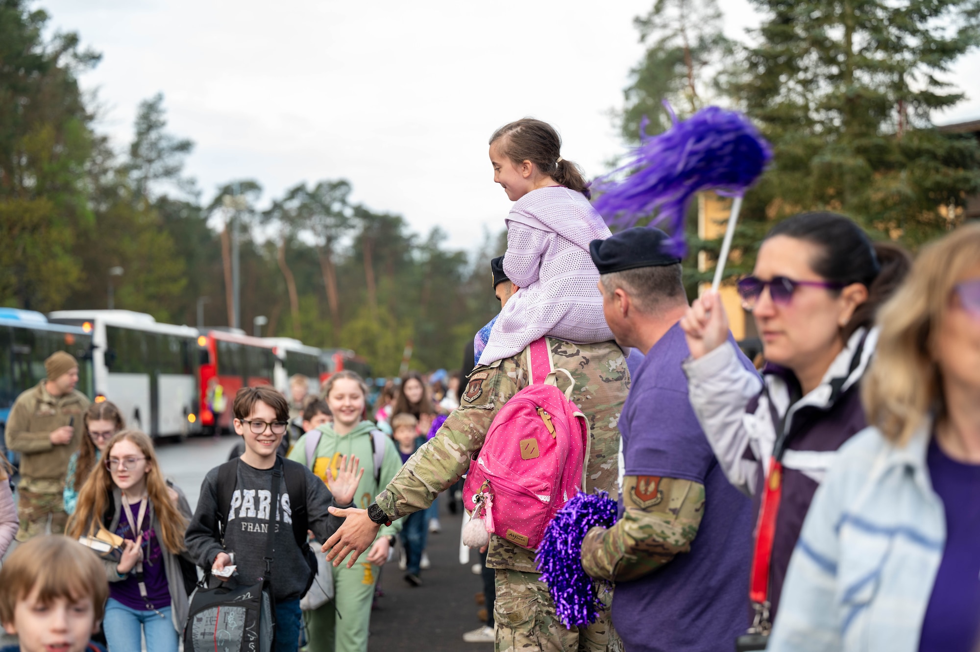 Members from the community line-up to greet children during Purple Up! Day at Ramstein Air Base, Germany, April 17, 2024.