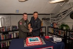 Capt. Daryle Cardone, commanding officer of the U.S. Navy’s only forward-deployed aircraft carrier, USS Ronald Reagan (CVN 76), and Scott Maskery, regional vice president for the United Service Operations (USO) Indo-Pacific regional office, cut a cake during the opening of a ship-based USO center aboard the ship while in-port Commander, Fleet Activities Yokosuka, April 17. Ronald Reagan, the flagship of Carrier Strike Group 5, provides a combat-ready force that protects and defends the United States, and supports alliances, partnerships and collective maritime interests in the Indo-Pacific region.