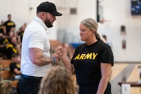 Team Army Coach Ross Alewine congratulates U.S. Army Maj. Amanda Feindt after the powerlifting event at the 2024 Army Trials at Fort Liberty, North Carolina