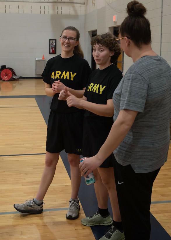 U.S. Army Spc. Brooke Jader, left, and U.S. Army 1st Lt. Hannah Wright, right, encourage fellow athletes during the powerlifting event at the 2024 Army Trials, Fort Liberty, North Carolina