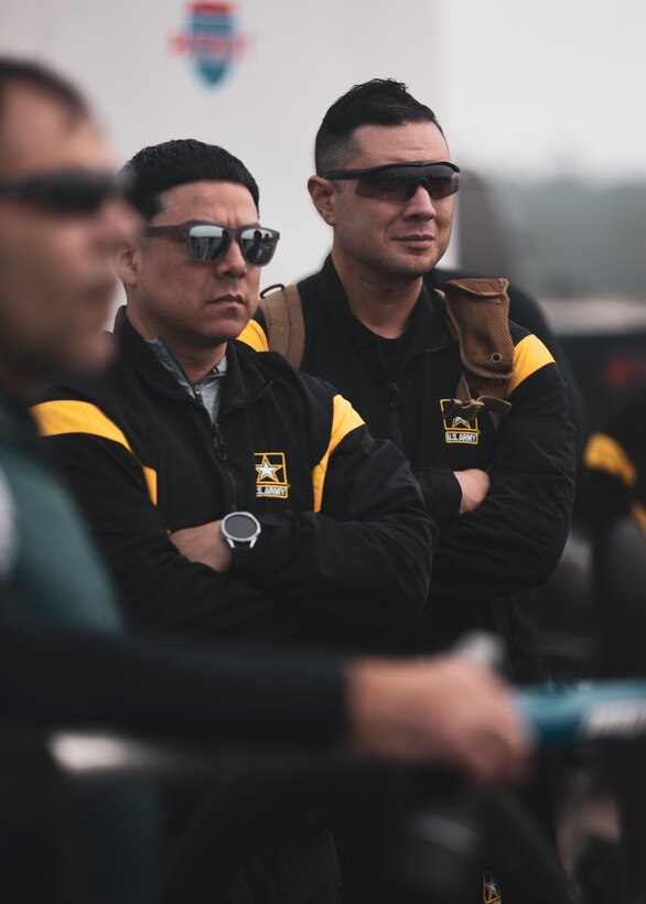 U.S. Army Chief Warrant Officer 2 Bowie Perez and Sgt. Daniel Pereyra listen to a briefing during the cycling event at the 2024 Army Trials, Fort Liberty, North Carolina