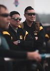 U.S. Army Chief Warrant Officer 2 Bowie Perez and Sgt. Daniel Pereyra listen to a briefing during the cycling event at the 2024 Army Trials, Fort Liberty, North Carolina