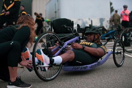 U.S. Army veteran Spc. Corine Hamilton gets assistance from mentor/coach Brandi Evans during the cycling event at the 2024 Army Trials, Fort Liberty, North Carolina