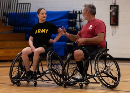 U.S. Army Spc. Avery Short, left, receives advice from U.S. Army veteran Christopher Parks during the wheelchair basketball event at the 2024 Army Trials, Fort Liberty, North Carolina