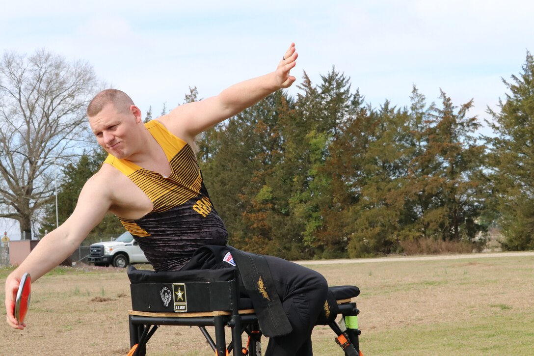 U.S. Army veteran Spc. Gerald Blakley reaches way back before throwing the discus  during the field event at the Army Trials, Fort Liberty, North Carolina